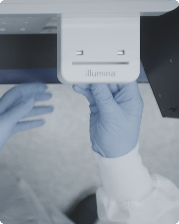 Scientist holding NextSeq 550Dx sequencing reagent